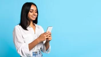 A imagem mostra uma mulher com traços indianos mexendo em um smartphone. Ela foi possivelmente impactada pelo conteúdo de alguma empresa que trabalhou o marketing no Instagram, tendo em vista que aparentemente está interagindo com alguma publicação.