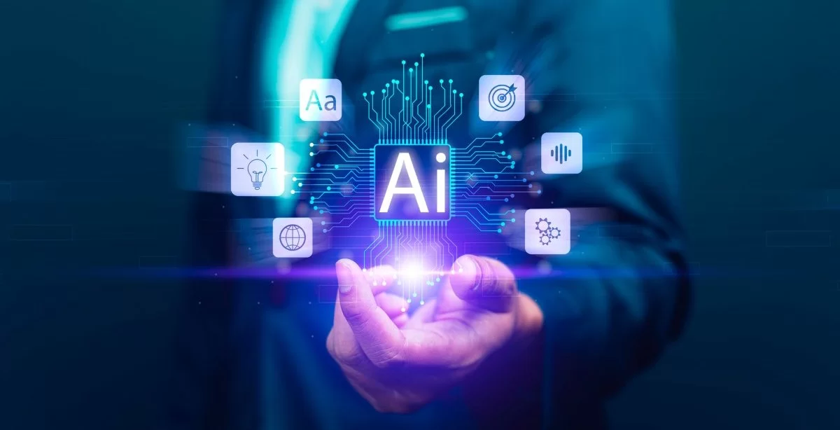 A imagem mostra um homem usando roupa social. Ele está com a mão esquerda a frente de seu corpo, ela está entreaberta e dela saem representações em forma de holograma que simbolizam um ecossistema processado por Inteligência Artificial.