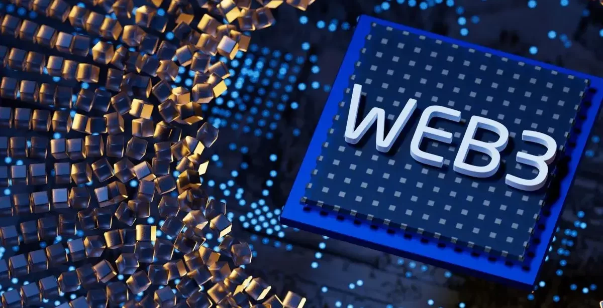 A imagem mostra o que parece ser um chip de computador com a palavra "Web3" escrita nele. Ela está em um ambiente que parece ser o interior de um grande computador, com algumas partículas se deslocando em direção ao "Web3".